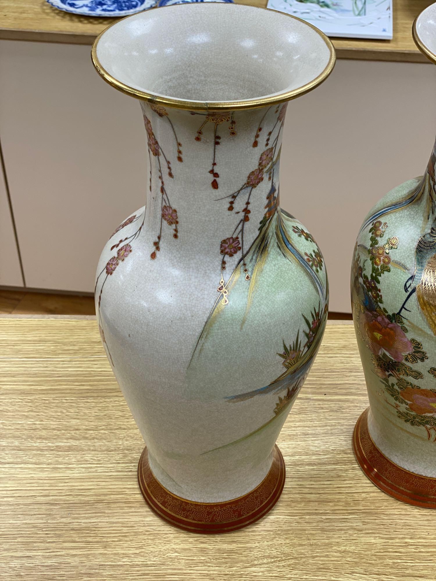 A pair of Japanese satsuma baluster vases, height 46cm, and a satsuma bulbous vase, height 37cm